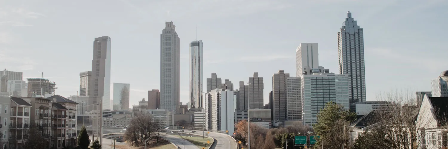 City skyline with tall buildings and road.